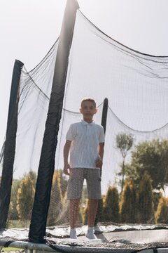 Happy Boy Enjoying Outdoor Trampoline Fun