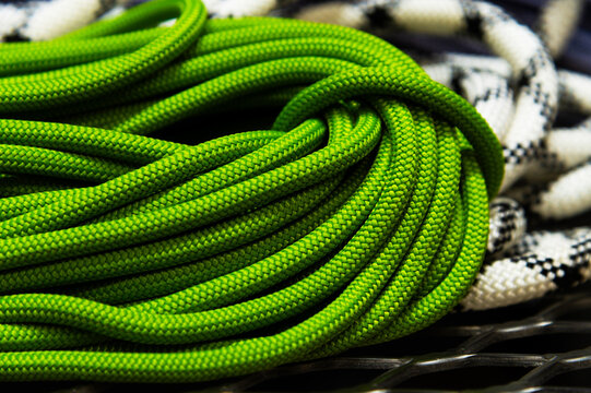 Green and white climbing ropes coiled together