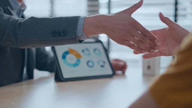 real estate agent and client shaking hands for a successful home insurance deal or property mortgage. Concept of house buying, financial agreement, and investment security at office