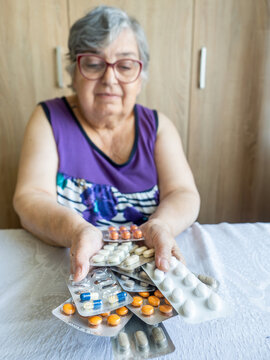 Senior Woman Holding Multiple Medication Blister Packs at Home
