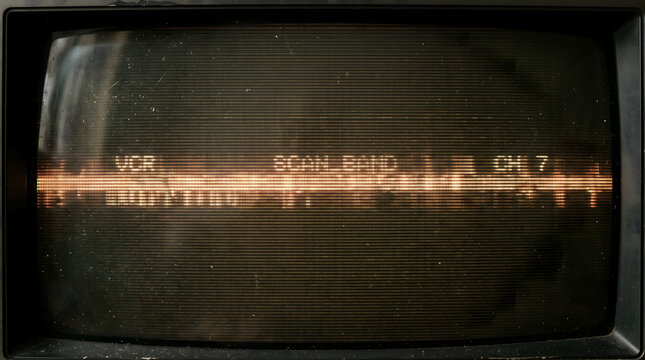 close up display of vintage retro television cathode ray tube monitor showing green horizontal scan band channel lines and glowing phosphorus pixels in darkness for analog tech concept