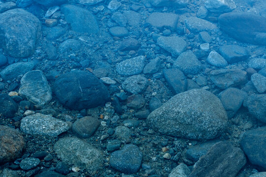 Clear Water Over River Rocks and Pebbles
