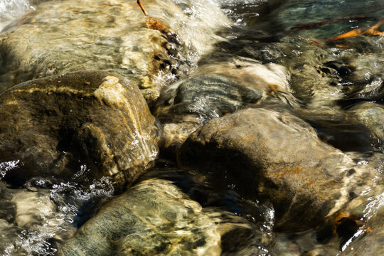 Clear Water Flowing Over River Rocks