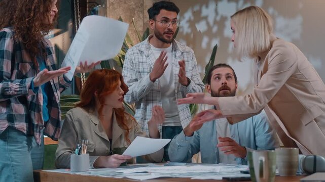 Five people feeling irritation arguing in casual informal business conference meeting throwing papers documents work team misunderstanding problem paperwork chaos Caucasian man boss leader frustrated