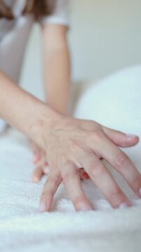 Therapist smooths oil along a womans forearm with both hands at a spa. Arm massage and skin care for spa, wellness and beauty relaxation marketing
