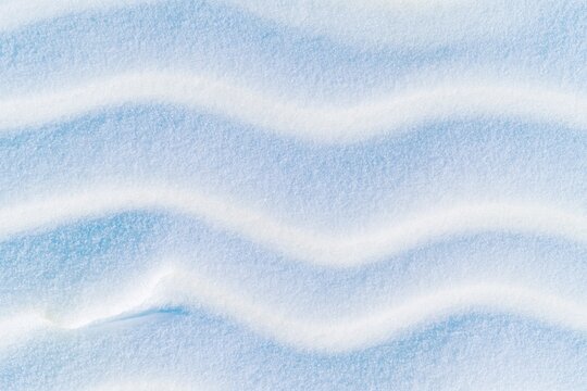Wavy snow surface with smooth winter ground texture and soft powder drifts for cold nature backgrounds and seasonal designs