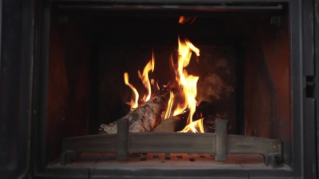 Burning Logs And Flickering Flames In Fireplace. Cozy Background For Home Ambience, Relaxation And Quiet Evenings.