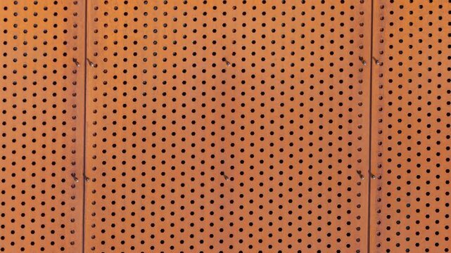 Perforated metal panel texture background