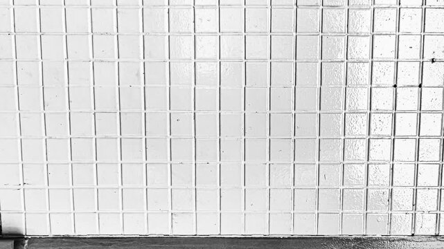 Abstract pattern of white tiles and metal