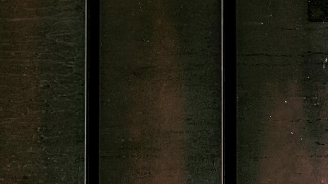 Dark metallic texture with vertical lines