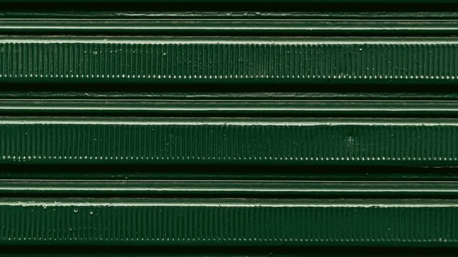 Dark green metal corrugated surface