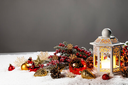 Christmas background with burning candles, ornaments and snow on blue