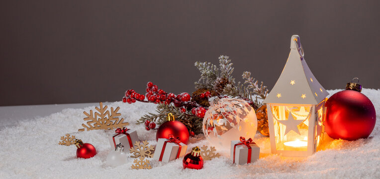 Christmas background with burning candles, ornaments and snow on blue