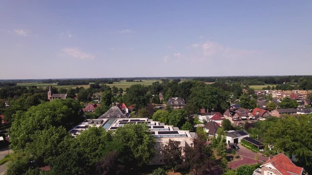 Aerial ascending reveal Dutch town Gorssel, The Netherlands, with MORE museum in the village art center seen from above
