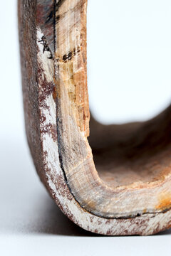 Section of industrial hot water boiler pipe with limescale deposits inside wall, reducing heat transfer efficiency, causing energy loss, corrosion, plumbing blockage, equipment failure