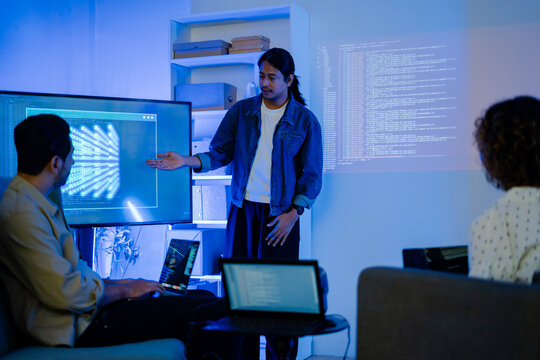 Diverse creative team use Ai Assistant (artificial intelligence assistant) on AI-assisted display for Marketing Data Analyst meeting at office.Coding team,develop Ai Assistant,business brainstorming