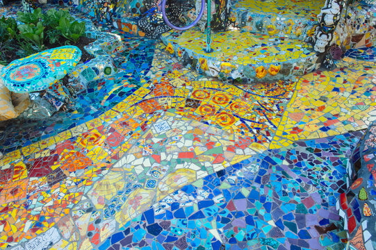 Colorful outdoor mosaic tile art in garden setting