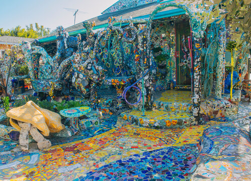 Colorful mosaic art decorating a house facade and yard in california