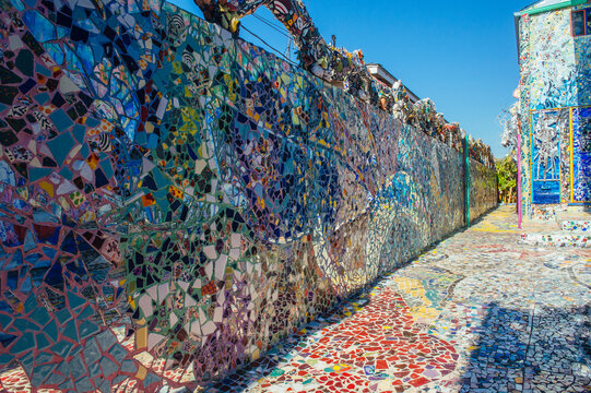 Colorful mosaic tile art decorating outdoor walls and pathway