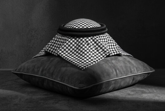 A luxurious Arabic-style shemagh, adorned with a black agal cord, resting on a pillow