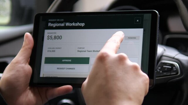 Executive reviews pending company spending requests on a tablet, highlighting budget approval, financial governance, cost control, and faster mobile business decisions.