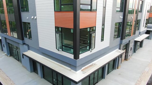 Aerial Rising Pedestal View of Commercial Building Corner Facade and Flat Roof