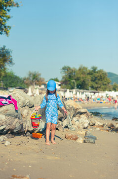 Carefree Little Girl Playing with Beach Toys on a Sunny Beach