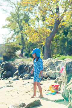 Carefree Little Girl Playing with Beach Toys on a Sunny Beach