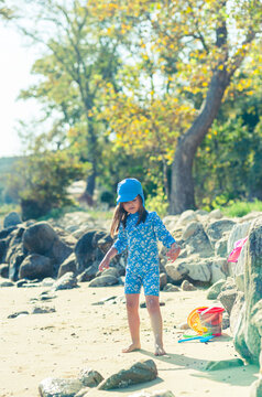 Carefree Little Girl Playing with Beach Toys on a Sunny Beach