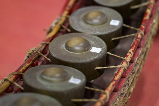 Thai gong circle, rows of bronze gongs in a curved wooden frame. The classical instrument represents authentic Thai musical heritage.