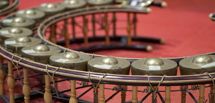 Thai gong circle, rows of bronze gongs in a curved wooden frame. The classical instrument represents authentic Thai musical heritage.