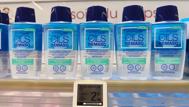 Royan, France - July 25, 2026: E.Leclerc ROYAN CEDEX. Maybelline Cils Demasq makeup remover bottles lined up on a shelf with a price tag visible in a retail store setting