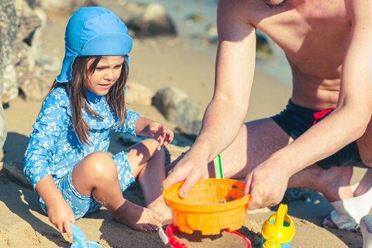 Father and Daughter Enjoying Quality Time Playing Together on the Beach