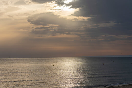 Langrune-Sur-Mer, France - 08 09 2026: Panoramic view of the sea, the beach and the sky with a ray of light reflecting on the water in the morning