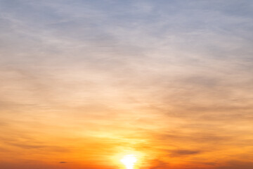 Obraz premium Sky sunset,Beautiful sunrise sky with vibrant gradient orange and gold colors and soft blue, Clear atmosphere with wispy clouds. Peaceful, perfect for background and copy space, High resolution images