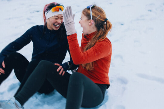 Women stop running to celebrate winter training with a high five