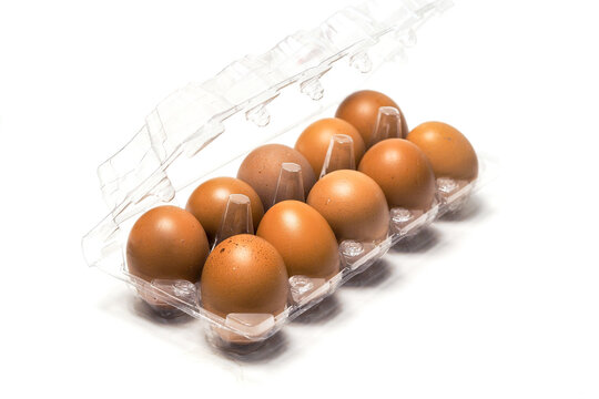 A full plastic container filled with fresh brown chicken eggs isolated on a clean white background.