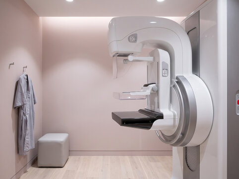 Mammography Imaging Unit Standing Ready in Bright Womens Health Screening Room With Soft Pink Accent Lighting
