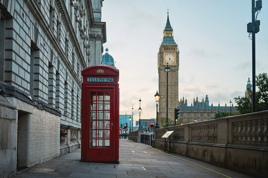 Red telephone box with Elizabeth Tower in Westminster, London