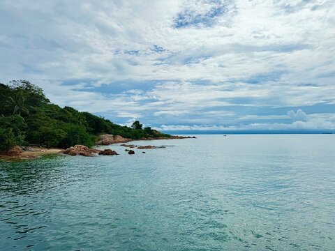 Scenic coastline view of Koh Man Nai island with rocky shore and turquoise sea in Rayong, Thailand