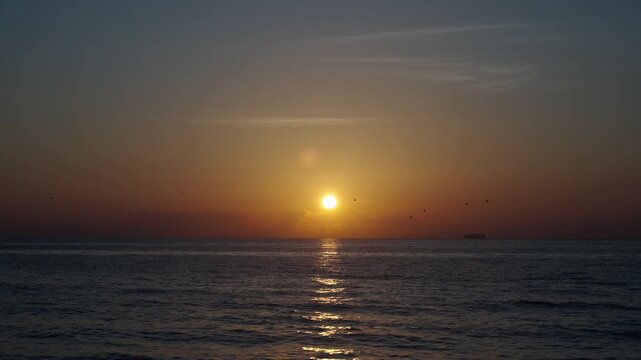 Sunset seascape at summer vacation. Sunrise with sea and beach. Calm horizon view at sea on sunrise. Romantic summer vacation view on seascape, 4k footage. Sea sunrise on ocean beach