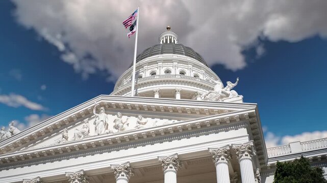 Time lapses show clouds racing across a blue sky above the California State Capitol in Sacramento throughout the day.