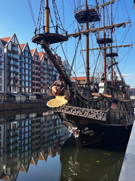 Vintage Wooden Pirate Galleon Ship Moored in City Harbor