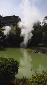 Shiraike Jigoku, "White Pond Hell", Kannawa, Beppu City, Beppu Jigoku, Japan, steaming hot spring pond at Hells of Beppu tour, Oita Prefecture, Kyushu Island, vivid mineral colored geothermal water