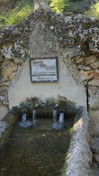 Fresh Water Flowing From an Ancient Stone Fountain