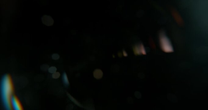 Slow motion of lens flare isolated on black background. Anamorphic lens. Cinematic glowing light overlay with optical streaks and rays for VFX compositing and transitions.