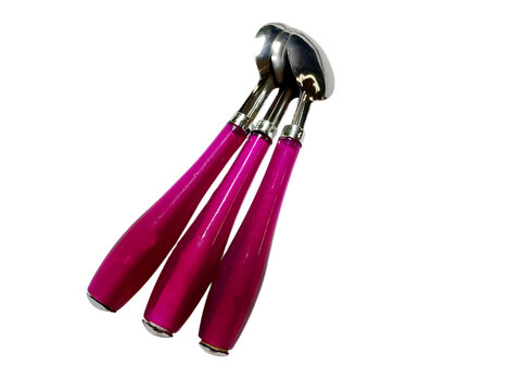 A collection of vibrant pink dessert spoons with silver detailing arranged on a white background