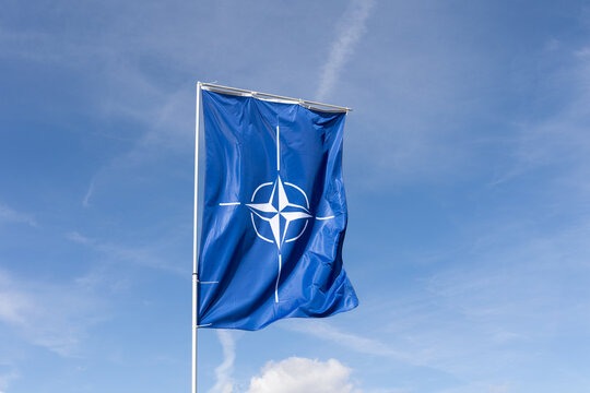 NATO Days, Ostrava Mosnov, September 19, 2026: Flag of North Atlantic Treaty Organization is waving in the wind. Blue sky as copy space. Military and defense allinace and union.