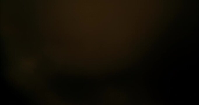 Slow motion of lens flare isolated on black background. Anamorphic lens. Cinematic glowing light overlay with optical streaks and rays for VFX compositing and transitions.