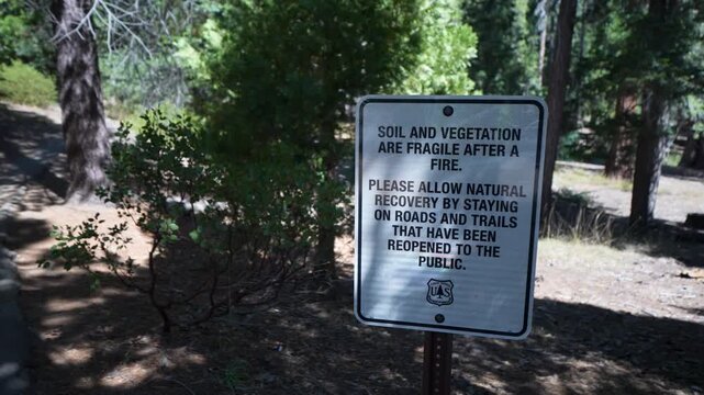 Signs inform visitors about the fragile soil and vegetation at Sequoia National Parks Trail of Giants in California.
